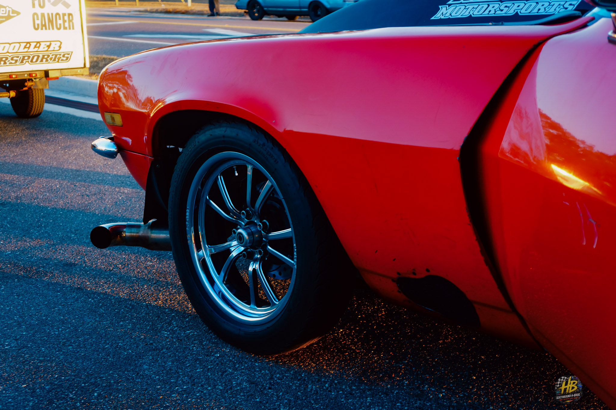 Red car wheel and quarter panel detail
